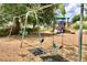 Community playground featuring swings, a slide, and a climbing structure surrounded by lush greenery at 2546 Oneida Loop, Kissimmee, FL 34747