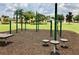 Community playground with workout stations for pull-ups, parallel bars, and elevated platforms for exercise at 2546 Oneida Loop, Kissimmee, FL 34747
