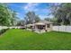 Expansive backyard features a well-maintained lawn, swimming pool, and ample space for outdoor activities and entertaining guests at 2579 Woodside Ridge Dr, Apopka, FL 32712
