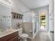 Bathroom with a vanity, shower, toilet, and door leading to the backyard at 2579 Woodside Ridge Dr, Apopka, FL 32712