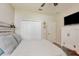 Bedroom featuring laminate floors, white walls, white closet doors, and a television at 2579 Woodside Ridge Dr, Apopka, FL 32712