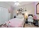 Cozy bedroom featuring wood floors, white walls, natural light, and decorated with string lights at 2579 Woodside Ridge Dr, Apopka, FL 32712