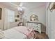 Charming bedroom with a white bed, wooden floors, natural light, and a decorative vanity at 2579 Woodside Ridge Dr, Apopka, FL 32712