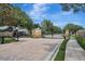 Gated community entrance with stone pillars, brick pavers, and lush landscaping, offering privacy and security to residents at 2579 Woodside Ridge Dr, Apopka, FL 32712