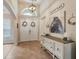 Elegant foyer with a decorative console table and grand double doors at 2579 Woodside Ridge Dr, Apopka, FL 32712