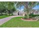 Charming home featuring a brick driveway, well-manicured lawn and mature trees at 2579 Woodside Ridge Dr, Apopka, FL 32712