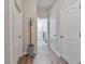 Hallway view with wood floors and multiple doorways at 2579 Woodside Ridge Dr, Apopka, FL 32712