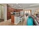 Spacious kitchen with an island, granite countertops and stainless steel appliances, open to the living room at 2579 Woodside Ridge Dr, Apopka, FL 32712