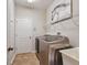 Laundry room with a washer, dryer, utility sink, and white walls at 2579 Woodside Ridge Dr, Apopka, FL 32712