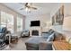 Cozy living room with a fireplace, large windows for natural light, and comfortable seating at 2579 Woodside Ridge Dr, Apopka, FL 32712