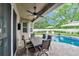 Covered patio with outdoor dining area offers a seamless transition to the backyard and pool, perfect for entertaining at 2579 Woodside Ridge Dr, Apopka, FL 32712