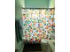Bathroom with a vibrant orange-themed shower curtain and modern fixtures at 2650 Autumn Creek Cir, Kissimmee, FL 34747