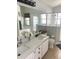 Bright bathroom with double sinks, a soaking tub, and a walk-in shower at 2650 Autumn Creek Cir, Kissimmee, FL 34747