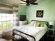 Relaxing bedroom with a ceiling fan, natural light, and neutral decor at 2650 Autumn Creek Cir, Kissimmee, FL 34747