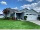 Charming single-story home with a well-manicured lawn and beautiful landscaping at 2650 Autumn Creek Cir, Kissimmee, FL 34747