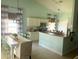 Bright kitchen with white cabinets, stainless steel appliances, and an eat-in dining area at 2650 Autumn Creek Cir, Kissimmee, FL 34747