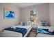 Charming bedroom featuring two twin beds with plush bedding and decor, illuminated by natural light at 2717 Camaro Dr, Kissimmee, FL 34746