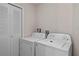 Functional laundry room features white washer and dryer set, with convenient storage space at 2717 Camaro Dr, Kissimmee, FL 34746