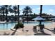 Resort-style pool area with lounge chairs and umbrellas, surrounded by lush landscaping at 2717 Camaro Dr, Kissimmee, FL 34746