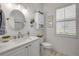 Bright bathroom with white cabinets, framed art, and shuttered window at 3017 Glin Cir, Ormond Beach, FL 32174