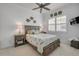Bedroom with a queen-sized bed, ceiling fan, and a large window with shutters at 3017 Glin Cir, Ormond Beach, FL 32174