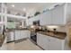 Modern kitchen with granite counters, stainless appliances, and bright, tiled backsplash at 3017 Glin Cir, Ormond Beach, FL 32174
