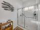 Walk-in shower with glass doors, grab bars, and built-in shelving at 3017 Glin Cir, Ormond Beach, FL 32174