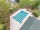Aerial view of a community swimming pool with lap lanes, lounge chairs, and a fenced-in area, perfect for recreation at 3017 Glin Cir, Ormond Beach, FL 32174