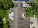 Overhead view of home showing a flat roof, multiple cars in driveway, mature trees and lake at 308 N Shadowbay Blvd # 214, Longwood, FL 32779