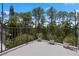 View of a flat outdoor balcony with black metal railing overlooking mature green trees at 308 N Shadowbay Blvd # 214, Longwood, FL 32779