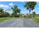 View of a paved basketball court next to lush landscaping, canal and waterfront homes at 308 N Shadowbay Blvd # 214, Longwood, FL 32779