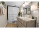 Bathroom featuring a vanity with a neutral countertop, complemented by a framed mirror and decorative lighting at 308 N Shadowbay Blvd # 214, Longwood, FL 32779
