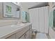 Bathroom showcasing a sink with neutral countertops, framed mirror, and decorative accents, providing a refreshing space at 308 N Shadowbay Blvd # 214, Longwood, FL 32779