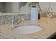 Bathroom featuring a granite countertop, a white sink, and modern fixtures, creating an inviting space at 308 N Shadowbay Blvd # 214, Longwood, FL 32779