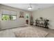 Bright bedroom featuring a large window with tree views and neutral decor with a ceiling fan and a plush rug at 308 N Shadowbay Blvd # 214, Longwood, FL 32779