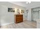 This light filled bedroom features wood floors and is appointed with a dresser and unique decorative elements at 308 N Shadowbay Blvd # 214, Longwood, FL 32779