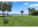 Community park on lake with mature landscaping, picnic benches and Adirondack chairs at 308 N Shadowbay Blvd # 214, Longwood, FL 32779