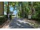 Gated community path leading to lake with mature trees on either side at 308 N Shadowbay Blvd # 214, Longwood, FL 32779