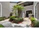 Charming courtyard with tropical plants and inviting walkway at 308 N Shadowbay Blvd # 214, Longwood, FL 32779