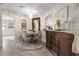 Cozy dining area featuring chandelier lighting, wood accents, and kitchen view at 308 N Shadowbay Blvd # 214, Longwood, FL 32779