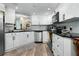 Bright kitchen with white cabinets, stainless steel appliances, and modern fixtures at 308 N Shadowbay Blvd # 214, Longwood, FL 32779