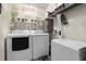 Well organized laundry room with modern washer, dryer, freezer, shelving and ample storage space at 308 N Shadowbay Blvd # 214, Longwood, FL 32779