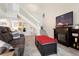 Inviting living room featuring staircase, modern TV, and cozy fireplace at 308 N Shadowbay Blvd # 214, Longwood, FL 32779