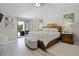 Spacious main bedroom with a private balcony, featuring a king-size bed and light, neutral decor at 308 N Shadowbay Blvd # 214, Longwood, FL 32779