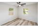 Inviting bedroom featuring wood-look floors, a modern ceiling fan, and natural light from two windows at 320 Eaton St, Maitland, FL 32751