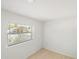 Bright bedroom featuring wood floors and a window overlooking a suburban neighborhood at 320 Eaton St, Maitland, FL 32751