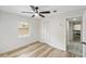 Well-lit bedroom featuring modern ceiling fan, closet and vinyl floors, plus access to an ensuite bath at 320 Eaton St, Maitland, FL 32751