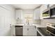 Bright, updated kitchen featuring white cabinets, stainless steel appliances, modern fixtures, and light countertops at 320 Eaton St, Maitland, FL 32751