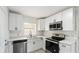 Bright, updated kitchen featuring white cabinets, stainless steel appliances, modern fixtures, and light countertops at 320 Eaton St, Maitland, FL 32751