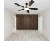 Living room with decorative wood paneling, a ceiling fan, and tile flooring, creating a stylish, modern look at 320 Eaton St, Maitland, FL 32751